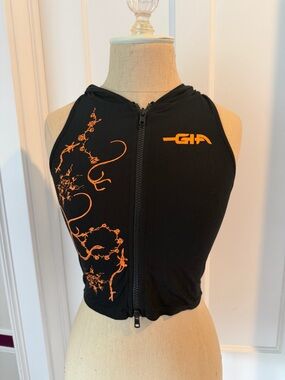 I. AM. GIA Black Zip Front Hooded Crop Top with Orange Graphic